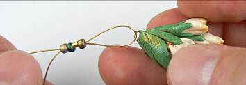 Beads on wire attached to clay flowers